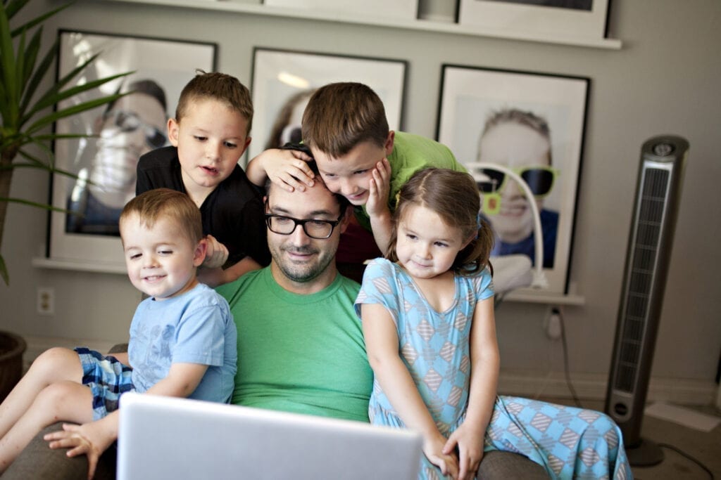 Dad and kids watching a computer