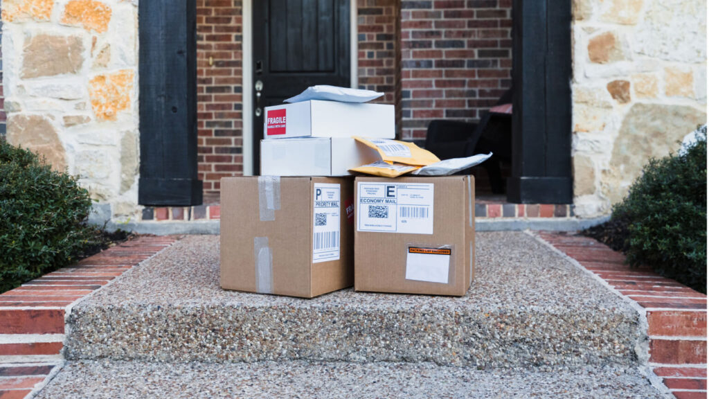 Stack of delivered packages on sidewalk