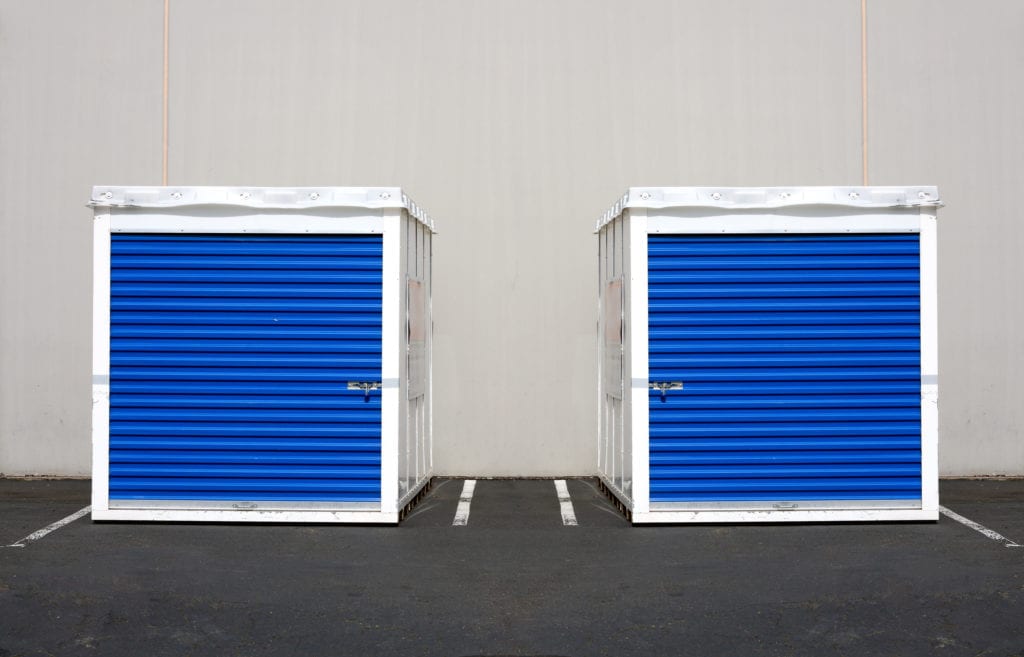 Two storage pods in parking lot